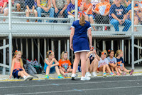 It was a hot day, and all the cheerleading clinic girls stayed in the shade before the game