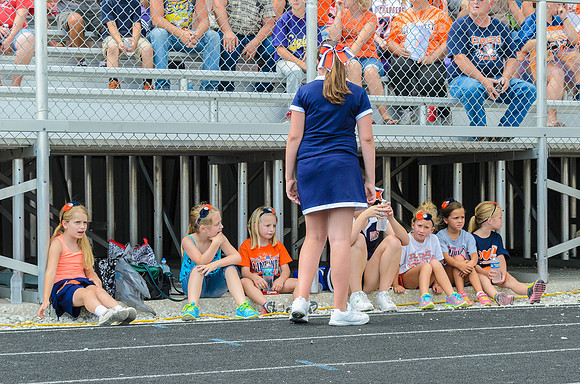 It was a hot day, and all the cheerleading clinic girls stayed in the shade before the game