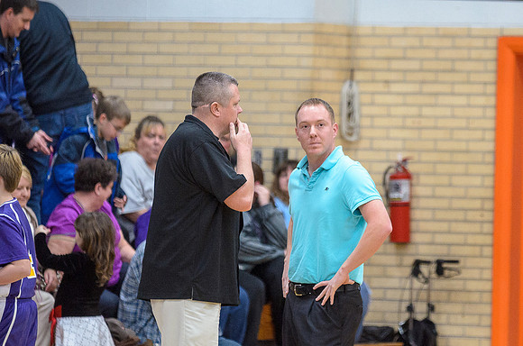 The coaches plotting a strategy during a timeout